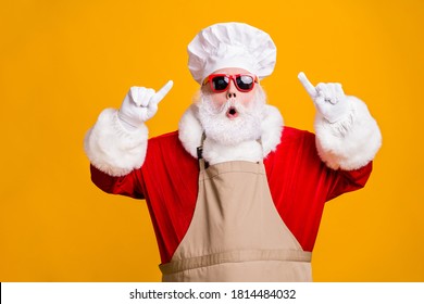 Photo of amazed santa claus point index finger chef hat christmas x-mas holly jolly meal preparation wear sunglass apron isolated over bright shine color background - Powered by Shutterstock