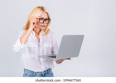 Photo Of Amazed Shocked Surprised Senior Mature Old Woman Holding Laptop Computer Isolated On White Grey Background.