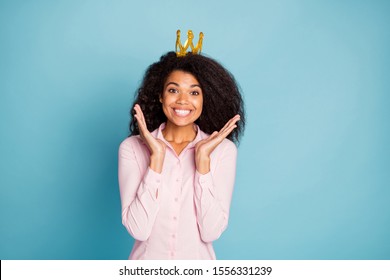 Photo of amazing dark skin lady overjoyed to be recognized as prom queen unbelievable emotions wear golden crown pink shirt isolated blue color background