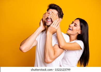 Photo Of Amazing Lady Hiding Eyes Macho Guy Making Unexpected Surprise Wear Casual White T-shirts Isolated Yellow Color Background