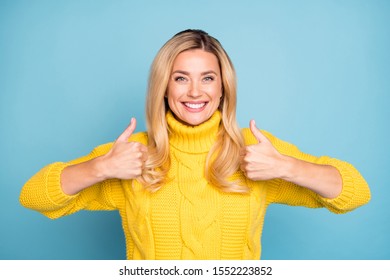 Photo of amazing pretty blond lady raising thumbs up expressing positive agree attitude new product wear warm knitted yellow jumper isolated blue color background - Powered by Shutterstock