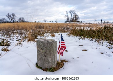 A Photo Of An American Flag Beside A Headstone On The Gettysburg National Military Park On The Field Of Pickett's Charge Where Union And Confederate Soldiers Battled In July Of 1863.