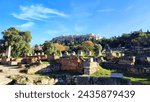 Photo of the ancient Agora of Athens, Greece with the majestic Parthenon Temple and the Acropolis hill in the backdrop.