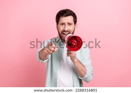 Photo of anger young businessman wear smart casual shirt proclaim bullhorn pointing finger you bad message isolated on pink color background