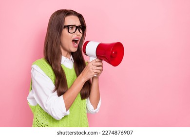Photo of angry boss young company business woman wear green vest scream noise microphone look mockup bad news isolated on pink color background
