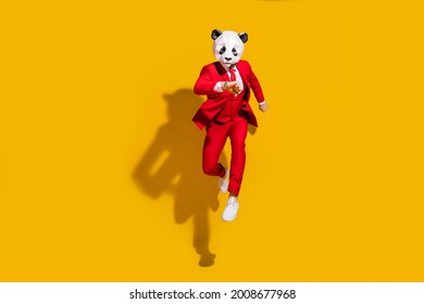 Photo Of Anonymous Panda Guy Jump Run Look Watch Late Wear Mask Red Tux Shoes Isolated On Yellow Color Background