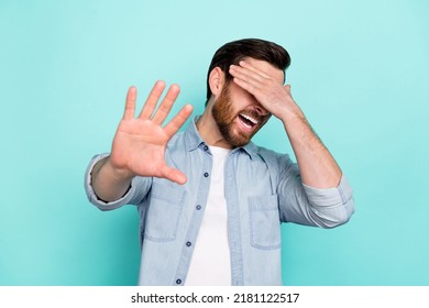 Photo Of Anxious Nervous Guy Hide His Eyes Not Want See Thriller Series Isolated On Cyan Color Background