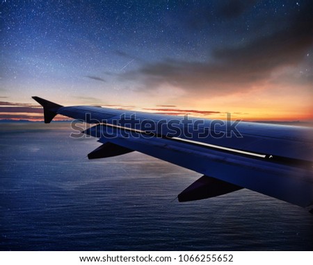 Photo applied to tourism operators. Landscape with passenger airplane is flying in the starry sky at night. Space background. Traveling concept.
