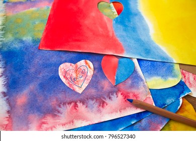 A photo of the artistic hand drawn abstract wet watercolor background, waldorf colorful template and a pencil. A lesson of drawing in Waldorf Steiner school, kindergarten
