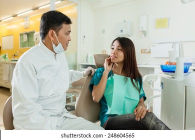 Photo Of Asian Female Patient Explaining Her Dentist That She Has Pain