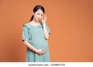 Photo Of Asian Pregnant Woman On Background