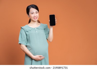 Photo Of Asian Pregnant Woman On Background