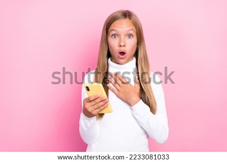 Photo of astonished impressed girl hand touch breast herself win gadget unbelievable really seriously me isolated on pink color background