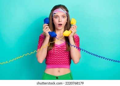 Photo Of Astonished Impressed Girl Straight Hairdo Pink Top Headband Talking On Landline Phones Isolated On Turquoise Color Background