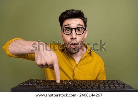 Photo of astonished man geek wear yellow stylish finger pointing keypad press button hacking website isolated on khaki color background Stock photo © 