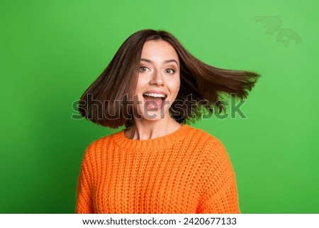 Photo of astonished nice lady open mouth flying shiny hair empty space isolated on green color background