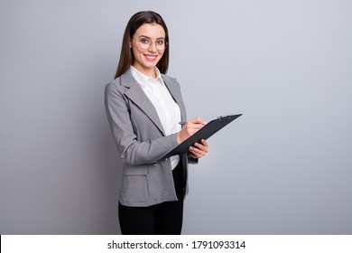 Photo of attractive business lady confident manager worker hold clipboard noting clients wishes real estate agent wear specs shirt plaid blazer isolated grey color background - Powered by Shutterstock