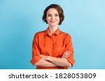 Photo of attractive charming lady cute bobbed hairdo arms crossed self-confident person worker friendly smile good mood wear orange office shirt isolated blue color background