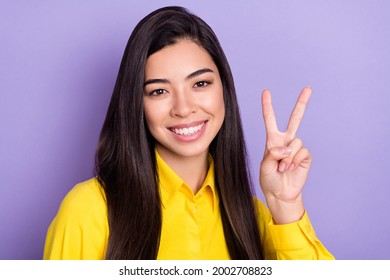 Photo of attractive charming young lady make v-sign smile cool good mood isolated on purple color background