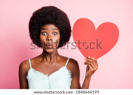 Photo of attractive curly hairdo lady arm hold heart symbol wear blue singlet isolated on pastel pink color background