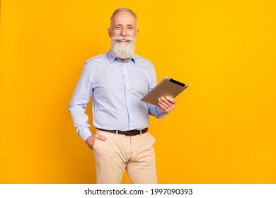 Photo Of Attractive Cute Age Gentleman Wear Blue Shirt Standing Holding Modern Device Empty Space Isolated Yellow Color Background