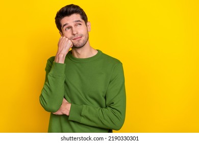 Photo of attractive dreamy guy dressed green pullover arm fist cheek looking empty space isolated yellow color background - Powered by Shutterstock