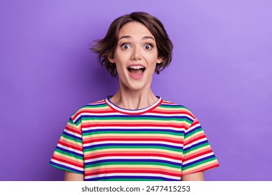 Photo of attractive funny excited lady looking on camera see big huge sales wear striped shirt isolated purple color background - Powered by Shutterstock