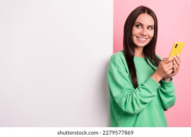 Photo of attractive girl brunette hair wear green shirt hold new smartphone look wallpaper promo online shop isolated on pink color background - Shutterstock ID 2279577869
