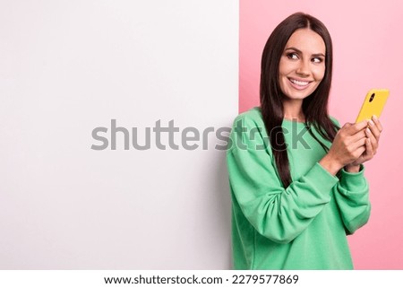 Photo of attractive girl brunette hair wear green shirt hold new smartphone look wallpaper promo online shop isolated on pink color background