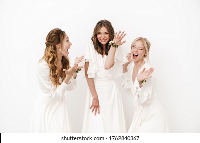 Photo Of Attractive Happy Bride Showing Her Wedding Ring At Excited Bridesmaids Isolated Over White Wall