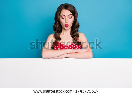 Photo of attractive interested lady stand lean hands empty advertisement banner sales manager read information wear summer red white dotted retro dress isolated blue color background