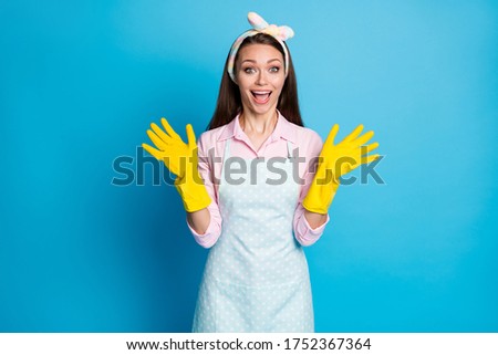 Photo of attractive lady house wife maid latex gloves on hands general spring cleaning good mood overjoyed tidy apartments wear headband dotted apron shirt isolated blue color background