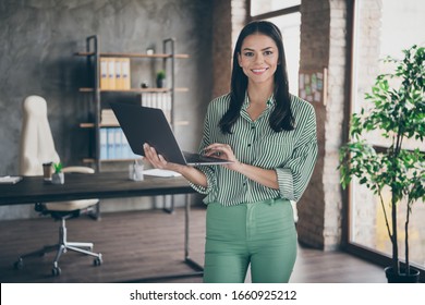 Photo Of Attractive Latin Business Lady Hold Notebook Chatting Colleagues Read Report Meet Partners Friendly Person Wear Striped Shirt Green Pants Stand Modern Interior Office Indoors