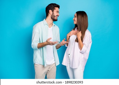 Photo of attractive man and woman married spouses have positive conversation isolated on blue color background
