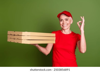 Photo of attractive mature woman professional pizza delivery employee okey wear red uniform workwear isolated on khaki color background - Powered by Shutterstock