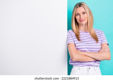 Photo Of Attractive Millennial Woman Folded Arms Serious Face Promo Big Billboard Rent Office Building Empty Space Isolated On Cyan Color Background