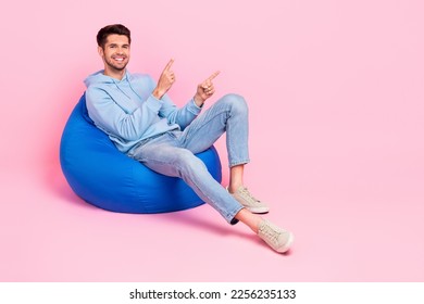Photo of attractive optimistic man wear trendy clothes two arm presenting empty space banner ad novelty isolated on pink color background - Shutterstock ID 2256235133