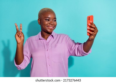 Photo of attractive person make selfie demonstrate v-sign blogging isolated on turquoise color background