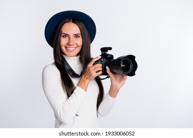 Photo of attractive positive photographer girl hold hands camera studio wear hat smile isolated on grey color background - Powered by Shutterstock