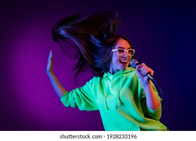Photo attractive positive young woman sign hold microphone isolated gradient violet color background