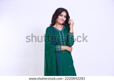 Photo of attractive pretty Pakistani woman smiling cheerful dreamy girl folded arms to herself in green Shalwar kameez and dupatta. Isolated on white color background