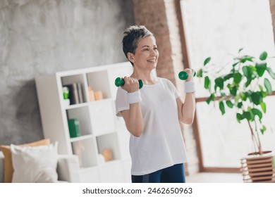 Photo of attractive senior woman dumbbells exercises sportswear home workout spacious bright living room sport concept - Powered by Shutterstock