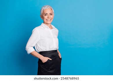 Photo of attractive senior woman small business cafe owner cheerful smile dressed waitress uniform isolated on blue color background - Powered by Shutterstock