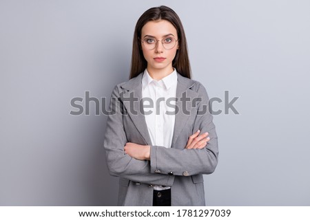 Photo of attractive strict business lady not smiling self-confident bossy manager worker arms crossed wear specs white shirt checkered blazer isolated grey color background
