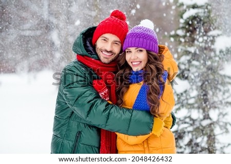 Photo of attractive sweet girlfriend boyfriend dressed vests smiling cuddling enjoying walking snow outdoors forest