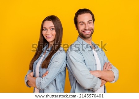 Photo of attractive sweet husband wife wear jeans shirts smiling arms folded isolated yellow color background
