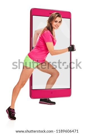 Photo of attractive young athletic running woman in sportswear, concept virtual reality of the smartphone. going out of the device