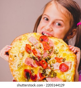 Photo Of Attractive Young Beautiful Girl Eats Big Slice Of Pizza. Vertical Image.