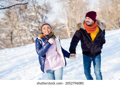 Photo of attractive young couple happy positive smile go walk run park hold hands together weekend winter snow