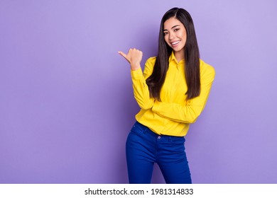 Photo of attractive young positive lady point finger empty space sale advice isolated on violet color background